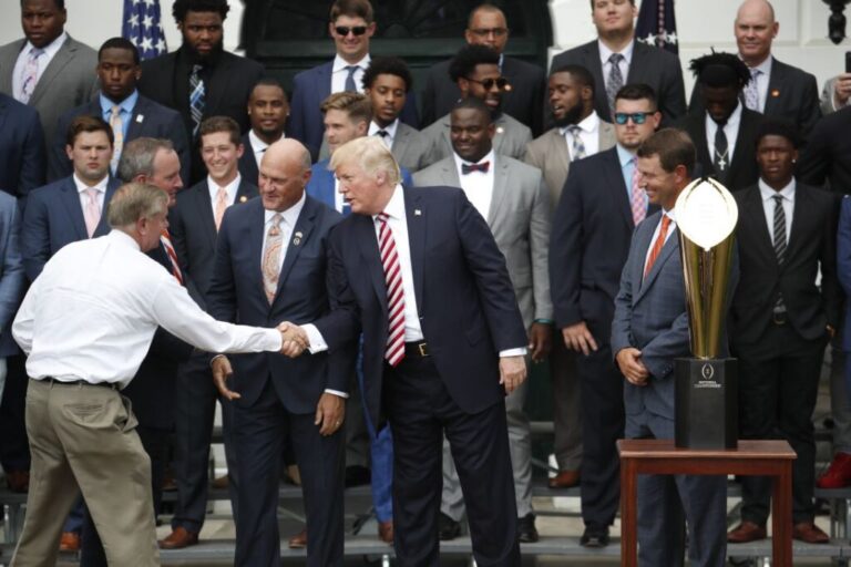 Trump shakes hands with Graham on the South Lawn of the White House on June 12, 2017.