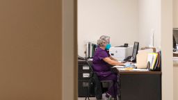In this December 2020 photo, a respiratory therapist works on a computer in her office in Lamesa, Texas.