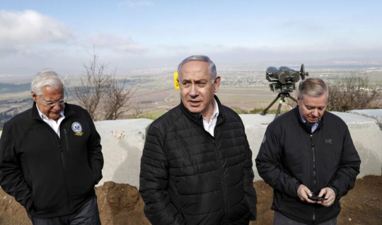 US Ambassador to Israel David Friedman is accompanied by Israeli Prime minister Benjamin Netanyahu and US Senator Lindsey Graham as they visit the border line between Syria and the Israeli-annexed Golan Heights on March 11, 2019.