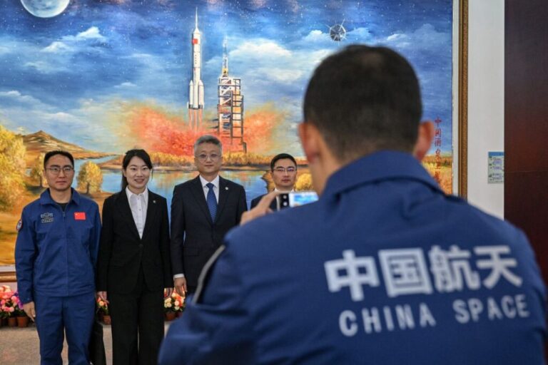 Zhang Jingbo (third from left), spokesperson for the China Manned Space Program, poses with staff members at the Jiuquan Satellite Launch Centre in China's Gansu province in 2025.