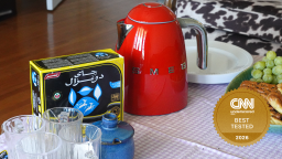 Red Smeg electric kettle next to tea