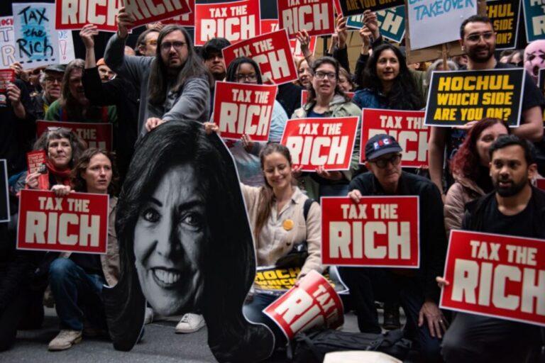 Ashik Siddique, bottom right, rallies along with politicians, activists, and community members outside Gov. Kathy Hochul's office in Manhattan on April 30, 2026. The ''Tax the Rich'' rally was organized by the Democratic Socialists of America.