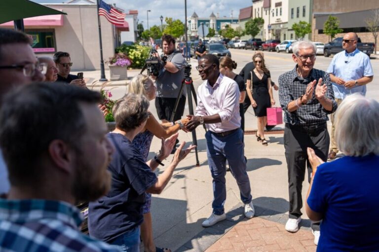 Crowley shakes hands with supporters while campaigning with Wisconsin Gov. Tony Evers, right, in Sheboygan, Wisconsin, on August 7.