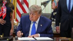 President Donald Trump signs an executive order about vaccines as Health and Human Services Secretary Robert F. Kennedy Jr., right, watches, Monday, Aug. 10, 2026, in the Oval Office of the White House in Washington. (AP Photo/Jacquelyn Martin)