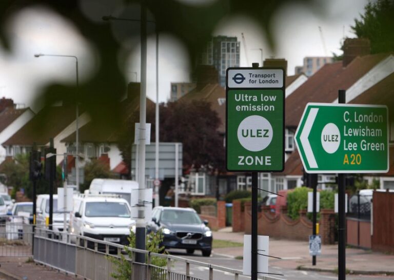 Signage indicates the boundary of London's Ultra Low Emission Zone (ULEZ) beside the South Circular road, in 2023.