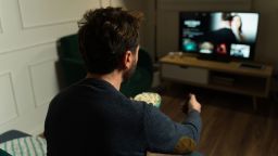 Man watching a movie using a streaming service while relaxing