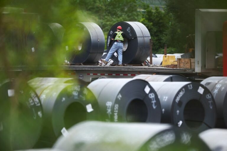 A worker secures a coil of steel at an ArcelorMittal Dofasco facility in Hamilton, Ontario, Canada, on August 24.