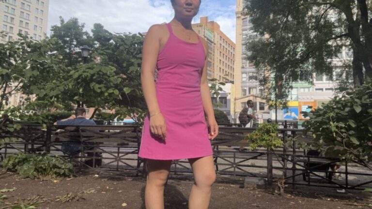 A woman wearing a pink Spanx cooling tennis dress