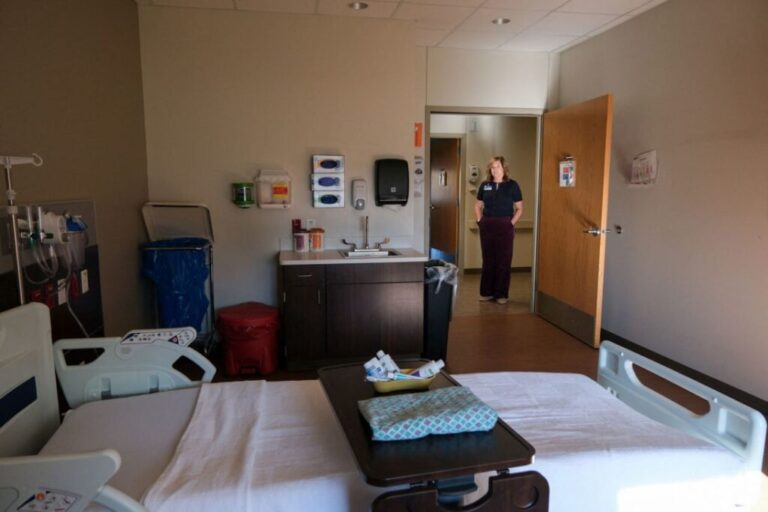 CEO Carrie Lutz looks into an inpatient care room at Holton Community Hospital in Holton, Kansas, in February.