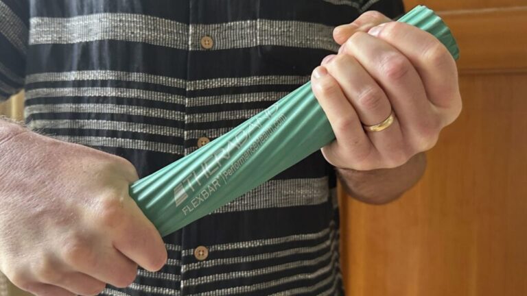 Person using the Theraband FlexBar Green.