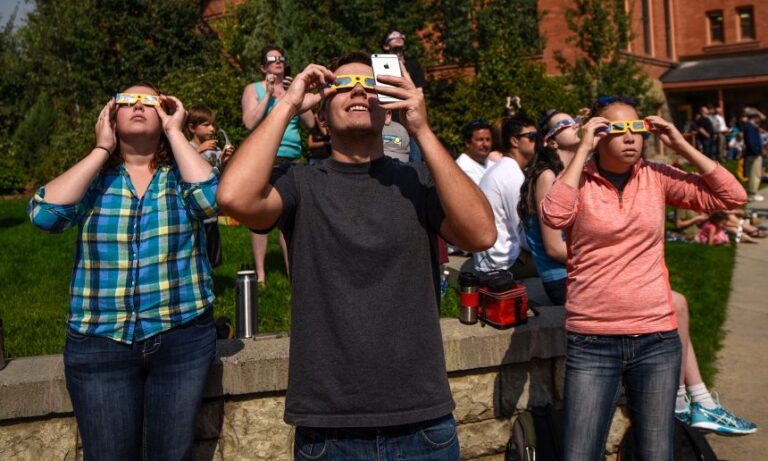 Students use eclipse glasses at Montana State University on August 21, 2017, in Bozeman, Montana.