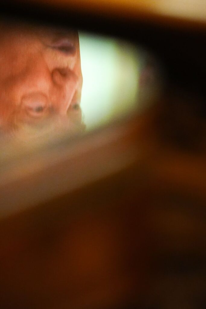 A reflection of President Donald Trump is seen in a table as he speaks about Dulles International Airport modernization at the White House, on July 29, in Washington.