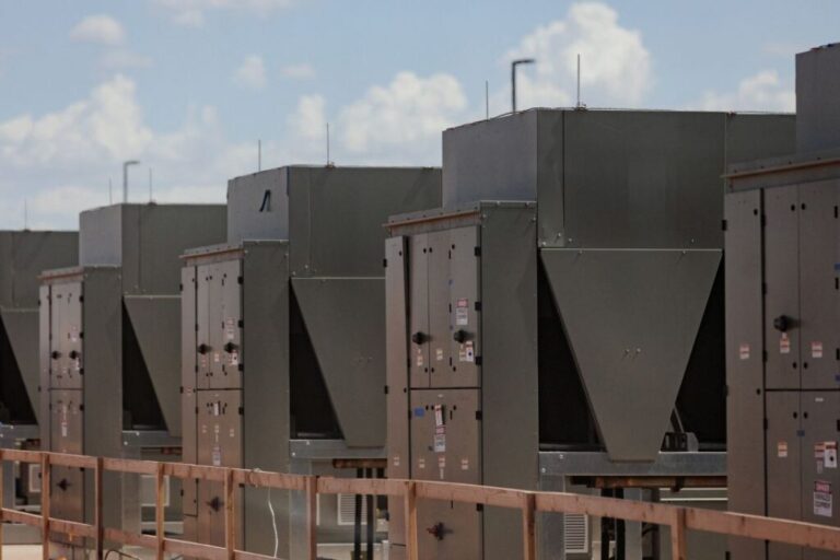 Chillers that cool water are connected to a data center building during a tour of an OpenAI data center in Abilene, Texas, in September 2025.