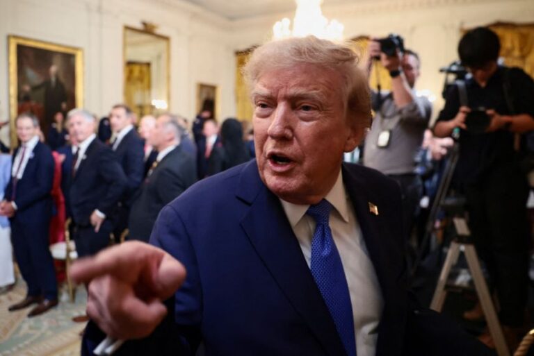 US President Donald Trump points a finger as he leaves the reception for Olympic athletes who competed in Milano Cortina, Italy, at the White House in Washington, D.C. on August 6.