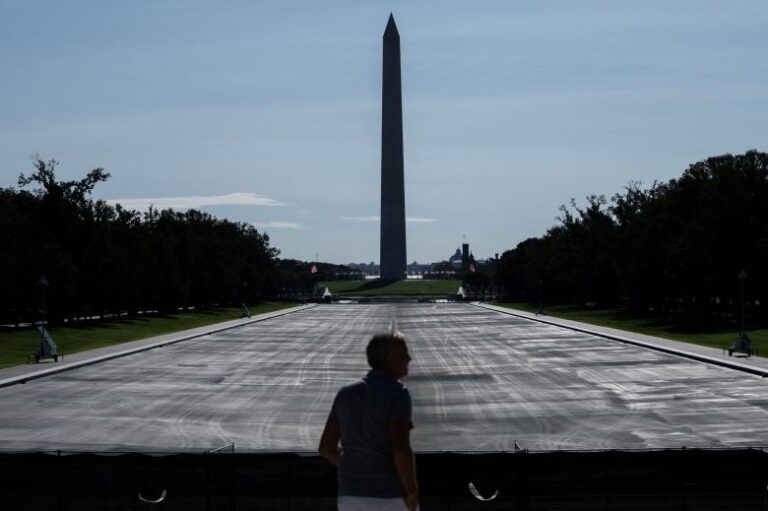 A visitor looks at ongoing construction at the drained Lincoln Memorial Reflecting Pool, following renovations and Independence Day celebrations, in Washington, DC, on July 30, 2026.