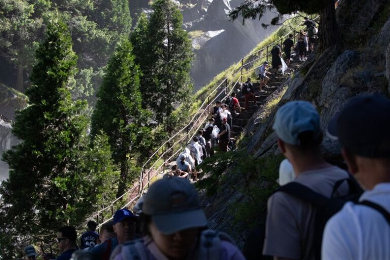 Tourists climb up the mist trail, one of the more popular hikes in California's Yosemite National Park, on June 13.