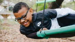 Mason Eichman, a 14-year-old boy with autism, swings in his backyard in San Antonio, Texas on April 19, 2026.