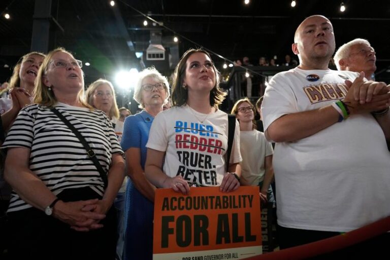 Audience members listen to Rob Sand speak during a campaign rally in Des Moines, on June 7.