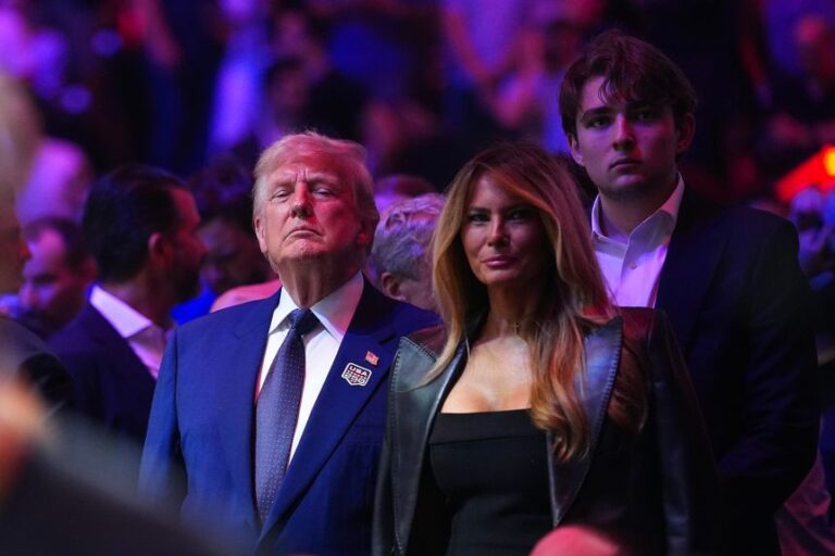 First lady Melania Trump stands between President Donald Trump and their son Barron Trump during the UFC Freedom 250 event on the South Lawn of the White House on June 14.