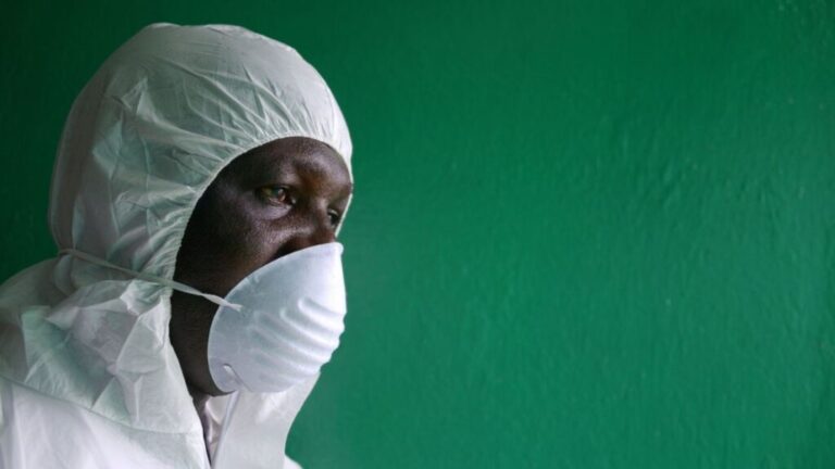 A health worker wearing a protective suit conducts an Ebola prevention drill at the port in Monrovia on August 29, 2014.