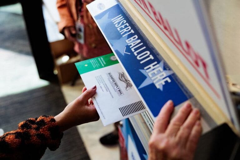 A person drops off a mail-in ballot on October 15, 2024 in Doylestown, Pennsylvania.