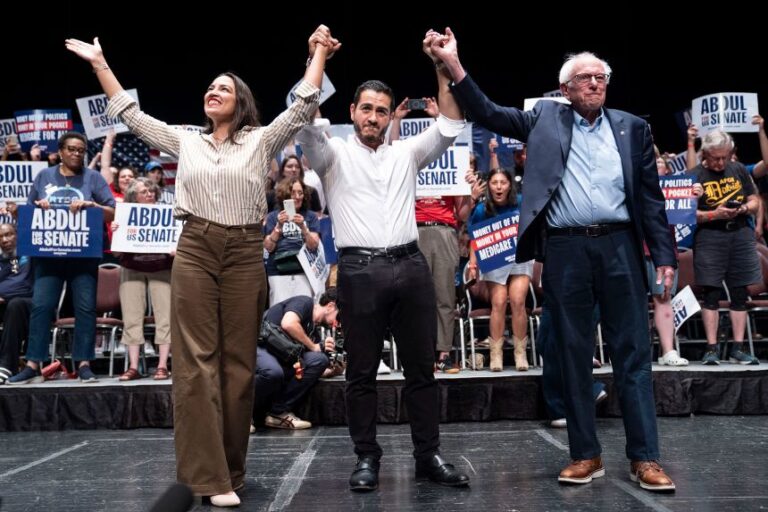 Rep. Alexandria Ocasio-Cortez, Abdul El-Sayed and Sen. Bernie Sanders greet the crowd after El-Sayed spoke at a rally in Detroit, Michigan, on July 18, 2026.