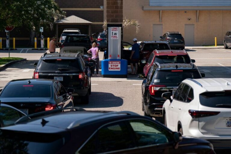 Vehicles wait to refuel at a Costco gas station in Wilmington, North Carolina, on Wednesday, July, 1.