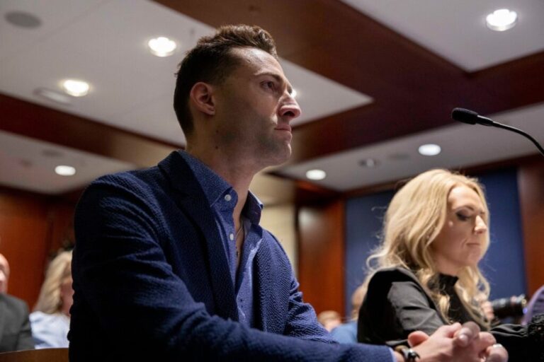 John Strand listens during an event hosted by Rep. Matt Gaetz at the US Capitol in June 2023.