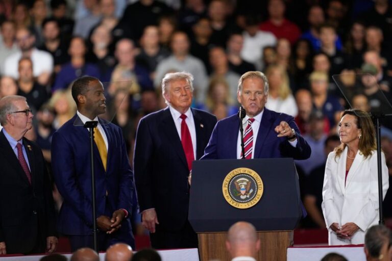 Republican Senate candidate Mike Rogers speaks as  President Donald Trump and Republican respresentatives listen at an event at the General Motors Proving Ground Monday, July 27, 2026, in Milford, Michigan.