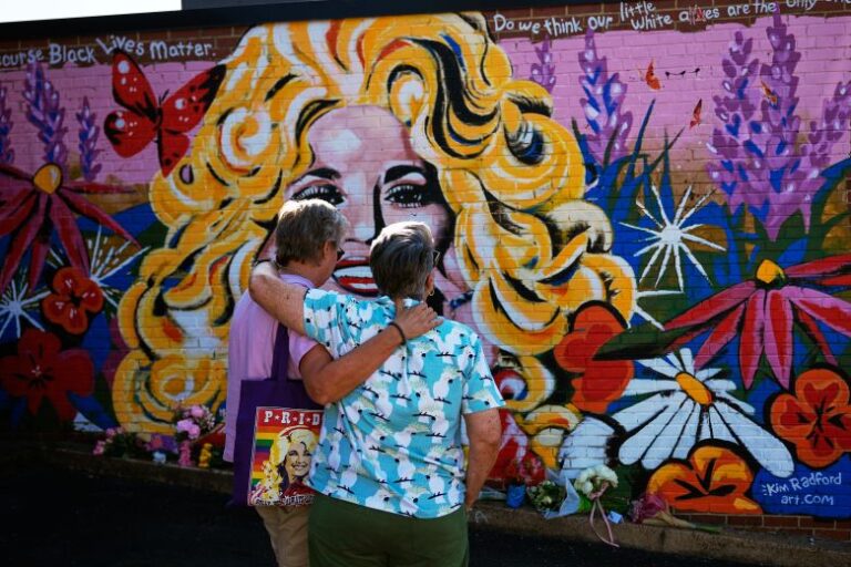 People visit a mural of Dolly Parton in Nashville on Tuesday.