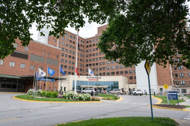 People wait to be picked up at the main entrance to the VA Medical Center in Kansas City, Missouri, in June 2025.