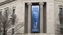 A banner of President Trump hangs from the Department of Justice building in Washington, DC on February 23.
