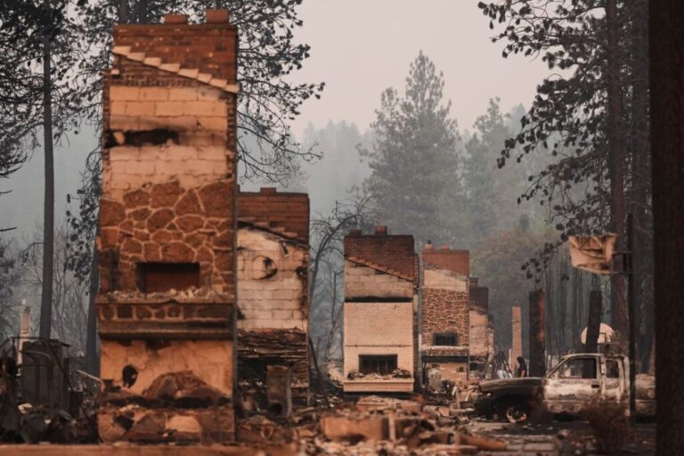 Chimneys are the only structures remaining in a residential neighborhood after a wildfire hit the northern part of Spokane, Washington, on August 3.