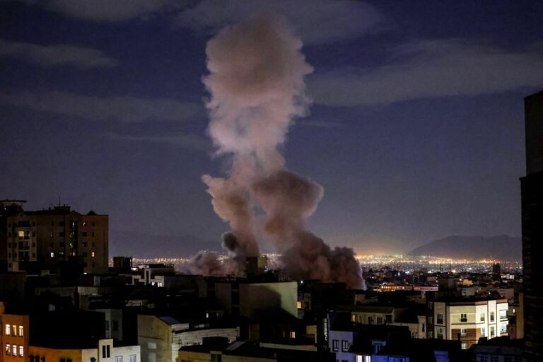 A smoke plume rises following a missile strike on a building in Tehran on March 1, 2026.