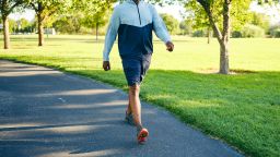 A mature black man, exercising in a park in the morning.