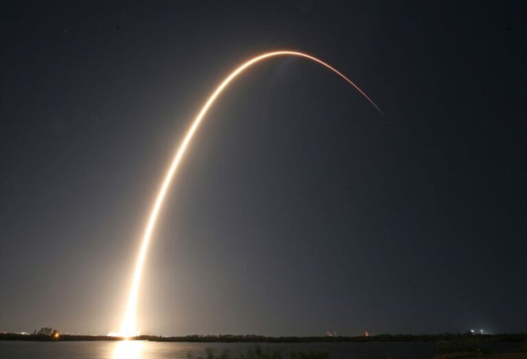 The SpaceX Falcon 9 rocket is seen arcing over the sky after liftoff in 2025.