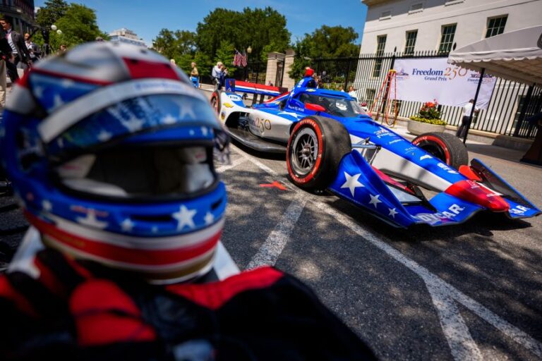 An IndyCar and a race helmet are visible at a Freedom 250 Grand Prix showcase near the White House on July 13.