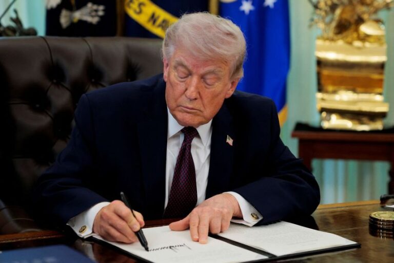 U.S. President Donald Trump signs an executive order on mail ballots, in the Oval Office of the White House in Washington, D.C., March 31, 2026.