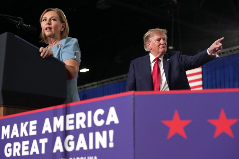 President Donald Trump listens as Sen. Darline Graham speaks during her campaign rally in Myrtle Beach, South Carolina, on August 21, 2026.