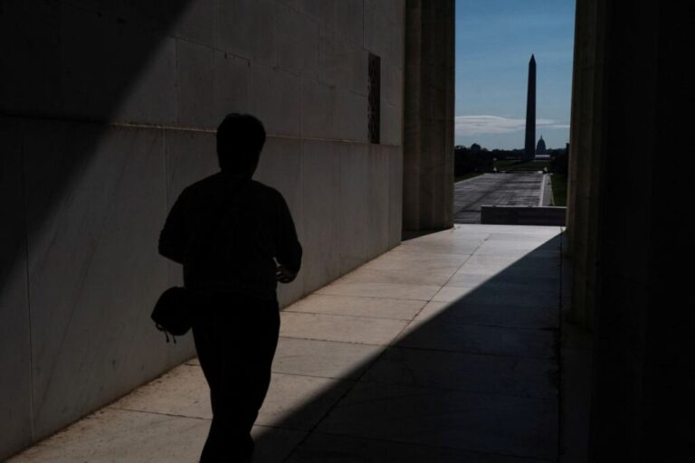 A visitor to the Lincoln Memorial walks near the drained Reflecting Pool, following renovations and Independence Day celebrations, in Washington, DC, on July 30.