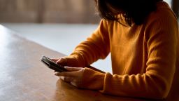 A woman who looking at her smartphone