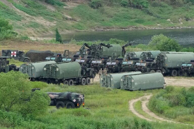 US Army armored vehicles gather to cross a river at a training field in Yeoncheon, South Korea, on Monday, August 17.