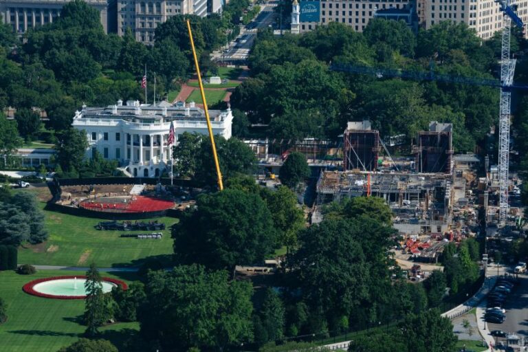 Construction continues on the White House helipad, left, and ballroom, right, on August 7, in Washington.