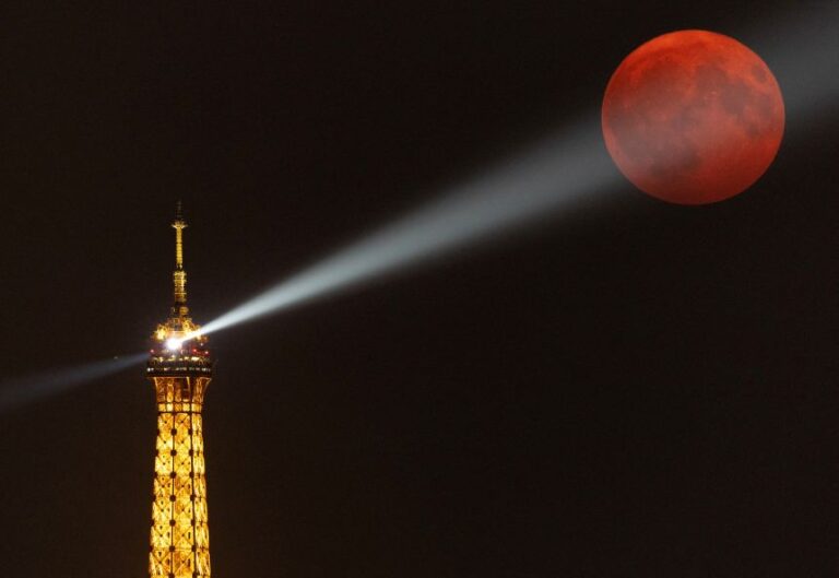 A sturgeon supermoon rises over the Eiffel Tower in Paris in August 2024.