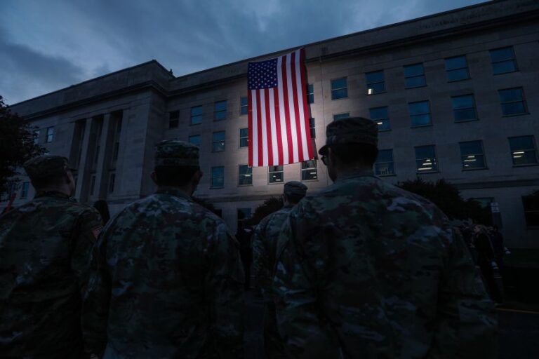 Military personnel and first responders watch as an American flag is raised alongside the Pentagon on the 24th anniversary of the September 11 attacks in Arlington, Virginia, on September 11, 2025.
