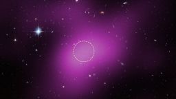 This image shows the location of Cloud-9, which is 14 million light-years from Earth. The diffuse magenta is radio data from the ground-based Very Large Array (VLA) showing the presence of the cloud. The dashed circle marks the peak of radio emission, which is where researchers focused their search for stars. Follow-up observations by the Hubble Space Telescope’s Advanced Camera for Surveys found no stars within the cloud. The few objects that appear within its boundaries are background galaxies. Before the Hubble observations, scientists could argue that Cloud-9 is a faint dwarf galaxy whose stars could not be seen with ground-based telescopes due to the lack of sensitivity. Hubble’s Advanced Camera for Surveys shows that, in reality, the failed galaxy contains no stars.