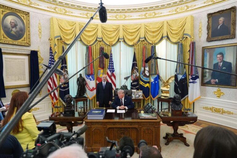 President Donald Trump answers questions from reporters after signing an executive order regarding mail-in voting in the Oval Office of the White House, on March 31.
