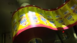 A spool of packaging for Juicy Fruit Minis chewing gum.