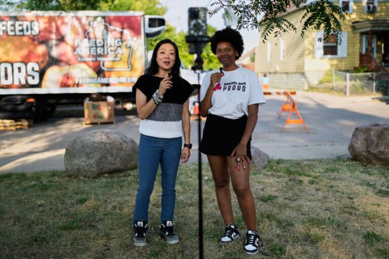 Francesca Hong talks with Metcalfe Park Communications Representative Nateya Taylor, during an event in Milwaukee, Wisconsin, on July 24.
