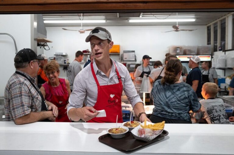 Rob Sand serves food at the Cattlemen's Beef Quarters concession at the Iowa State Fair in Des Moines, on August 15.